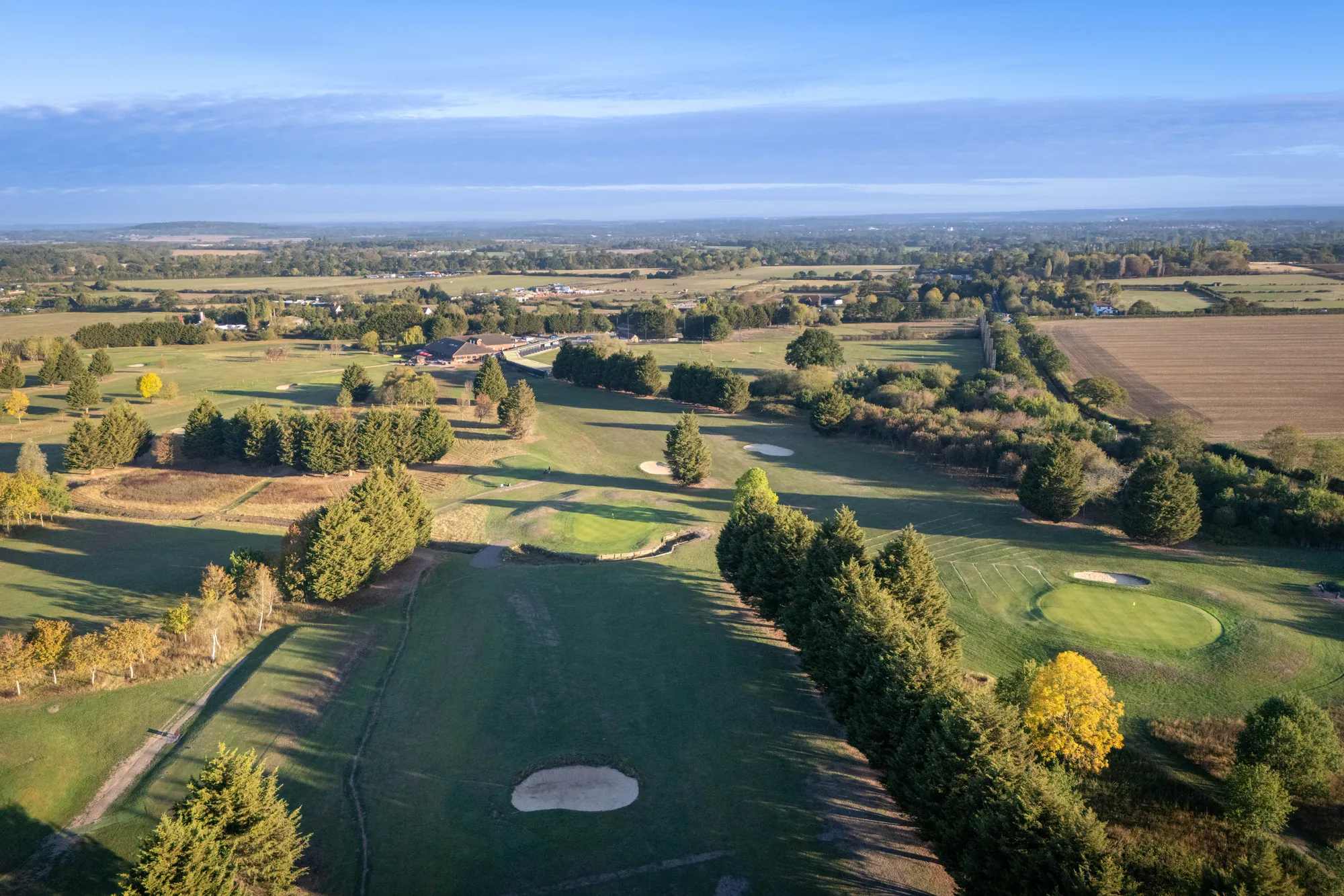 Fairways and tree lines across the course from the air