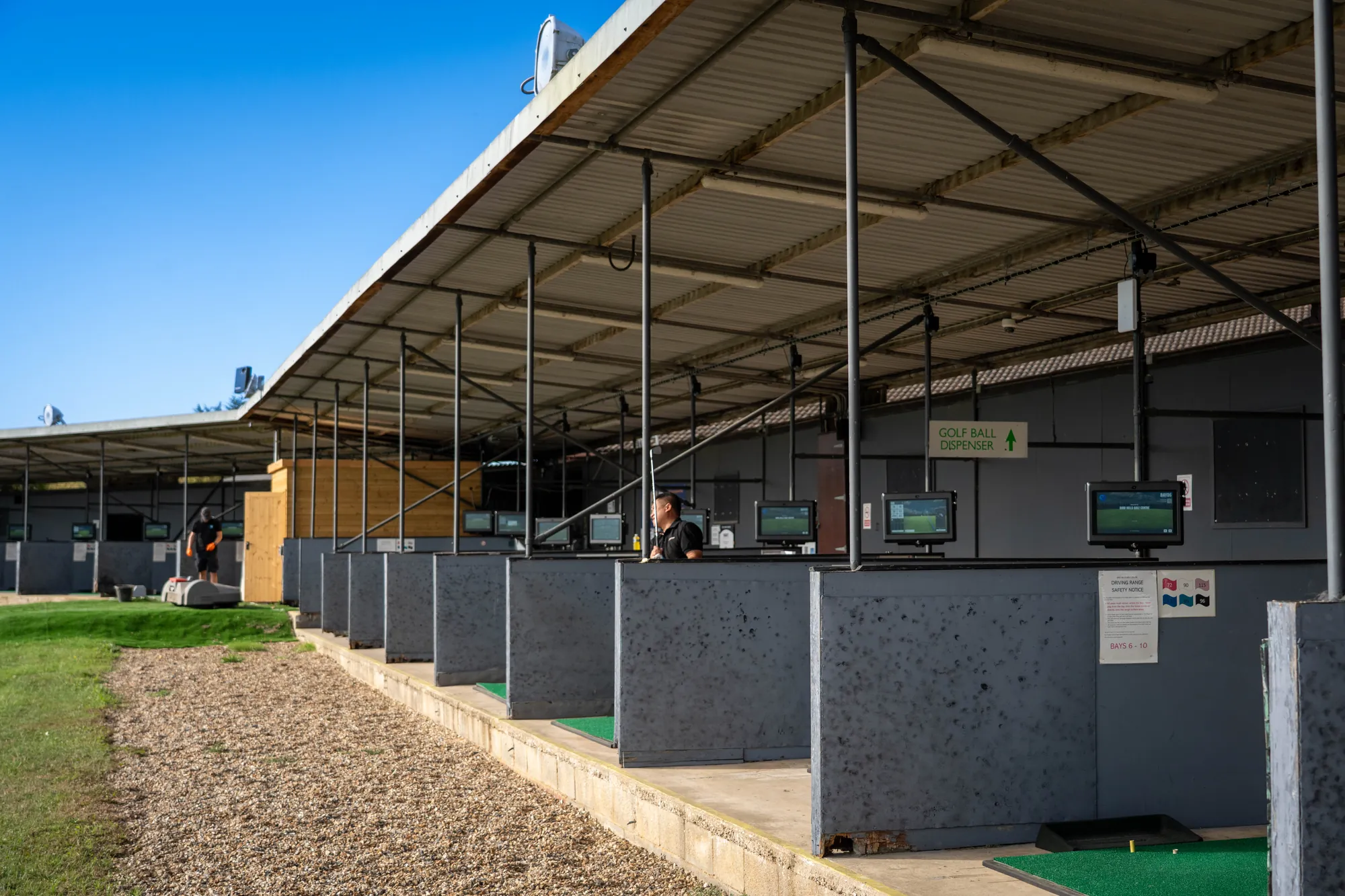 The covered bays stretching along the driving range